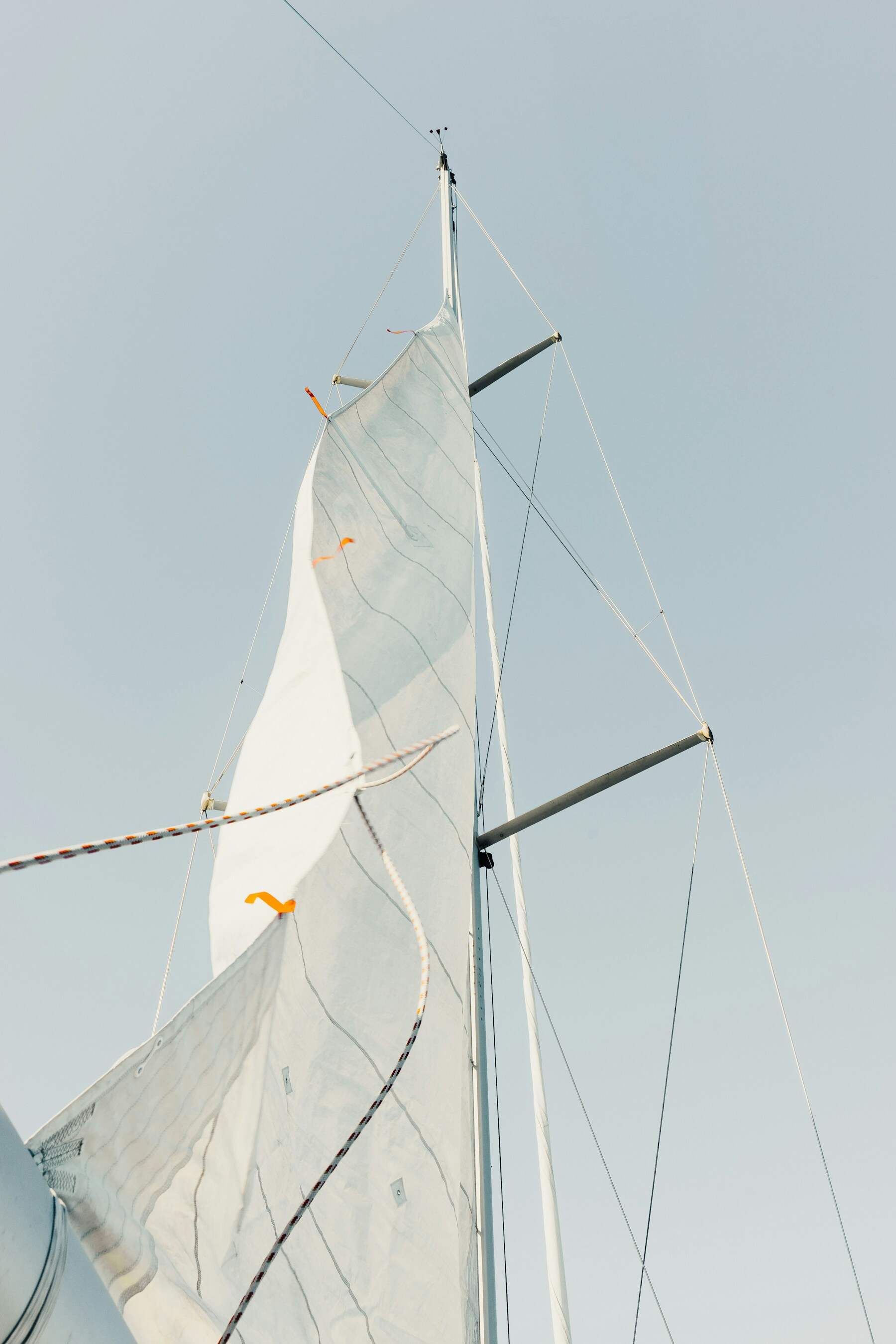 Unbranded sail rigging cutting a precise line across open sky